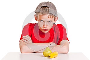 Belligerent young boy with fruit photo