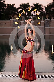 Belly Dancer in Red Costume with Fire Fans