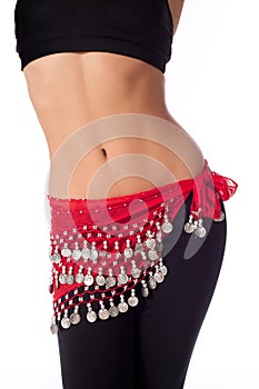 Belly Dancer Wearing a Red Coin Belt and Workout Clothing