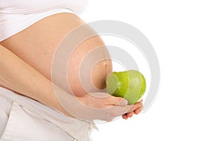 Belly pregnant woman with an apple in profile