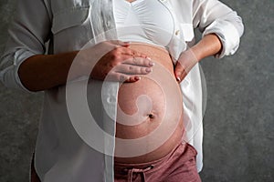 Belly of a pregnant woman. Pregnancy concept.