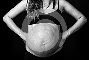 Belly of a pregnant woman, superhero concept.