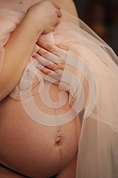 belly of pregnant woman with a veil on the body