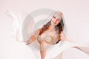 Bellydancer with veil smiling at camera