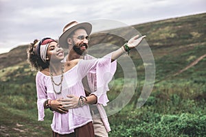 Beloved man and woman embracing on nature hills