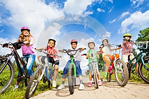 Below angle view of kids in helmets with bikes