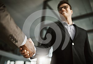 Below of two business peoples handshake during a meeting in an office. Colleagues finalize a successful promotion, deal photo