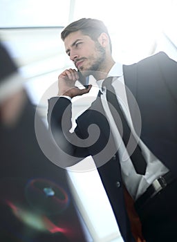 Below view of businessman in suit with cellular phone