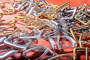 Belt buckles on red full grain leather background