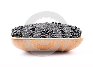 Beluga lentils in bamboo bowl on white background