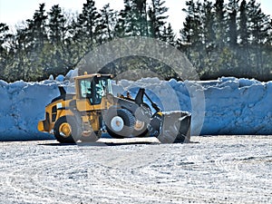 Front end loader takes short rest and tilts back on two wheels during job photo