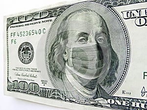 Ben Franklin wears a protect Healthcare Mask on a One Hundred Dollar Bill Illustrates the many costs of the Coronavirus outbreak