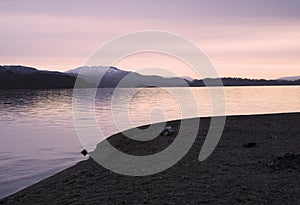 Ben Lomond at Loch Lomond during pink sunrise sky in Scotland