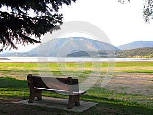 A bench in beautiful scenic area of lake and mountain