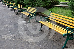 Bench chairs seating in Public park in a row at Ravangla Buddha Park in South Sikkim, India. Metal deck chairs stand in a row