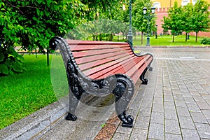 Bench in a city park on a rainy summer day
