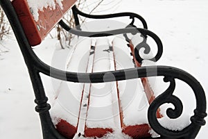 Bench covered with snow