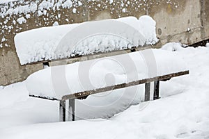 Bench covered with thick layer of snow