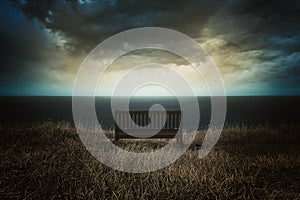 Bench in front of a dramatic cloudscape