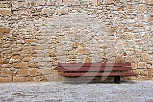 Bench in front of natural stone masonry
