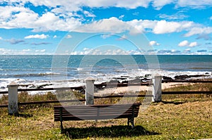 Bench in front of the sea on the beach of La Paloma in Uruguay