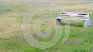 Bench on a green meadow with blur