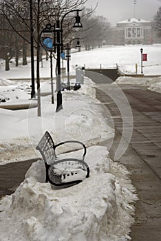 Bench hidden in snow at plaza in Madison Wisconsin