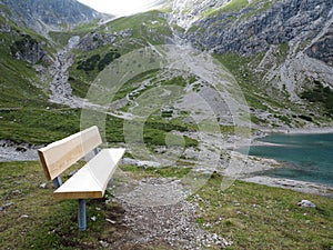 Bench lakeside in high alpine landscape