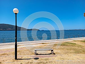 Bench, lantern, promenade and the sea