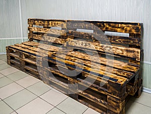 Bench made of wooden pallets decorated with roasting