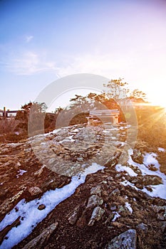 Bench on Marginal Way path at sunset in Ogunquit Maine during winter