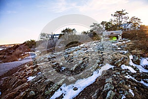 Bench on Marginal Way path at sunset in Ogunquit Maine during winter