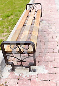 Bench on the pavement in the park