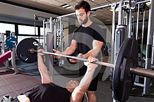 Bench press weightlifting man with personal trainer