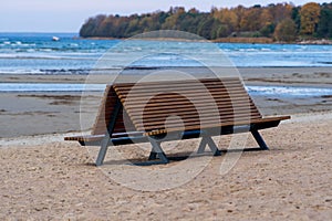 Bench for rest and relaxation on a deserted abandoned beach on the Baltic Sea in Estonia