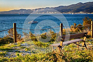 Bench by the sea. Waiting for the sunset on the cliff. A place of solitude