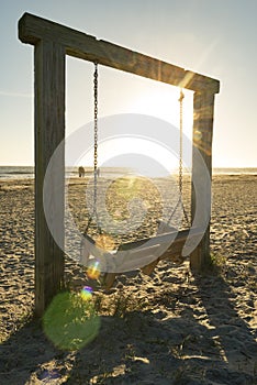 Bench on the seashore in sunburst morning sun