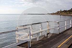 A bench seat on the Granite Island Causeway looking towards to granite island located in Victor Harbor South Australia on August 3