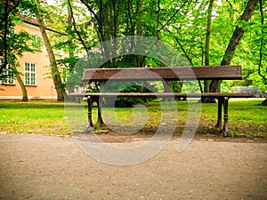 Bench on sidewalk walking pavement in park. landscape.