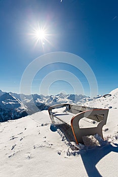 Bench in ski resort Bad Gastein in winter snowy mountains, Austria, Land Salzburg