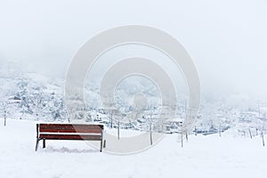 Bench and snowy winter landscape photo