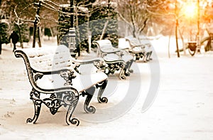 Bench in snowy winter park