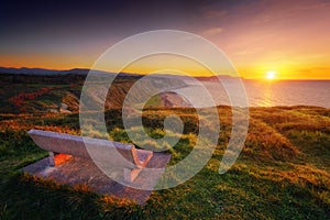 Bench at sunset with view of Azkorri beach in Getxo photo