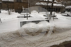 Bench under snow at Campus Mall in Madison Wisconsin