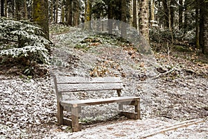 Bench under snow at park in winter time