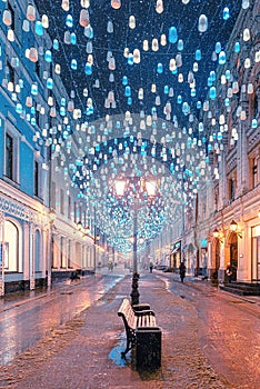 A bench under a street lamp. Stoleshnikov pereulok in Moscow.