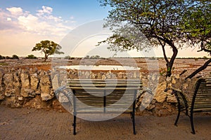 Bench at the waterhole of Okaukuejo Campsite in Etosha National Park, Namibia