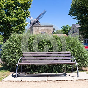 Bench and windmill in werder (havel) photo