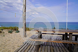 Bench wooden pic nic table sandy beach view in summer day on Cap Ferret coast France