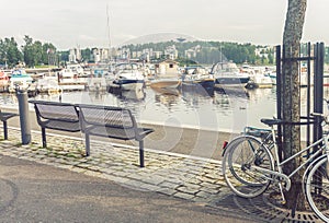 Benches, bicycles and boats on the embankment of Jyvaskyla, Finl